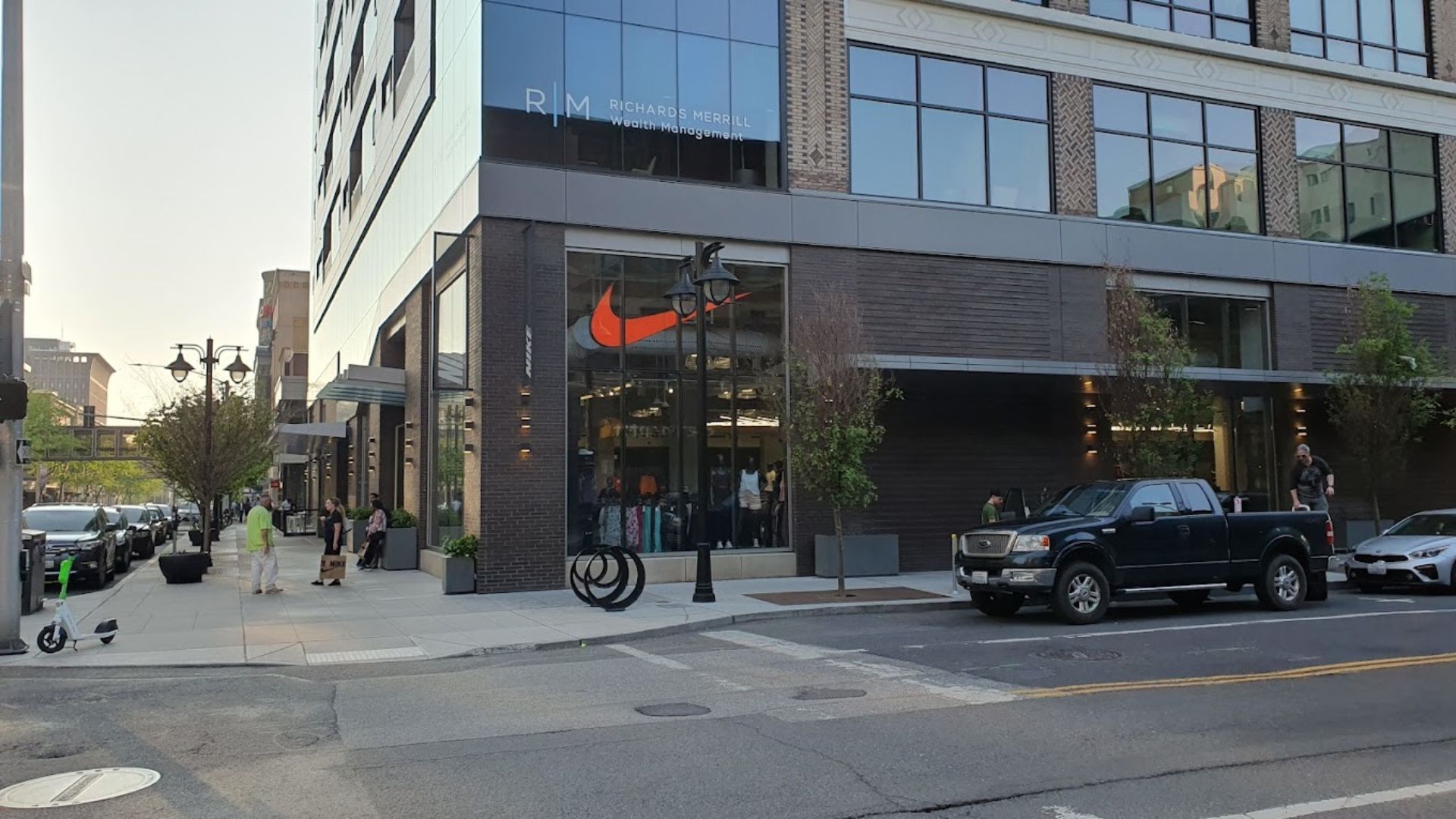 Street view of the Nike Store building in Downtown Spokane with Richard's Merrill Wealth Management, pedestrians and vehicles visible.
