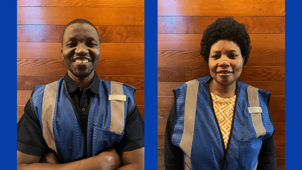 Jan-Pro cleaning staff employees in blue safety vests smiling at camera